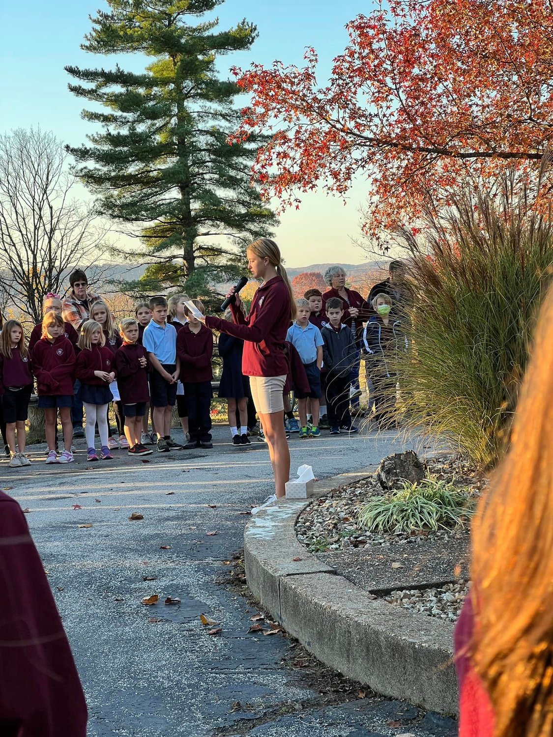 Students of St. George School in Hermann join Father Philip Niekamp, pastor of St. George Parish in Hermann and Church of the Risen Savior Parish in Rhineland, for Mass in St. George Cemetery in Hermann for All Souls Day.